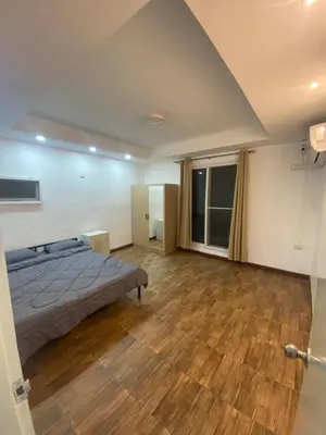 a bedroom with a bed and a wooden floor at Am Am Place 2 Near Rajamangkala Stadium in Sathani Khlong Tan