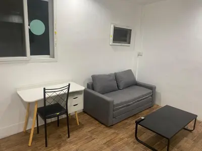 a room with a couch and a desk and a chair at Am Am Place 2 Near Rajamangkala Stadium in Sathani Khlong Tan
