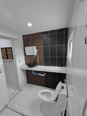 a bathroom with a toilet and a sink at Am Am Place 2 Near Rajamangkala Stadium in Sathani Khlong Tan