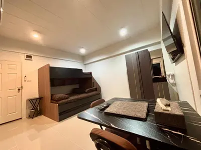 a dining room with a table and a bed in a room at Rong-Pak BangRaMat by Modi Coff Café in Sathani Ban Chim Phali