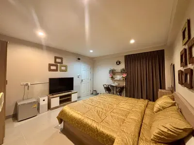 a bedroom with a bed and a flat screen tv at Rong-Pak BangRaMat by Modi Coff Café in Sathani Ban Chim Phali