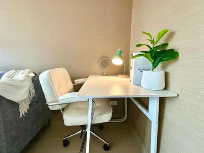 a desk with a chair and a potted plant on it at Studio with view near Ekkamai in Bangkok