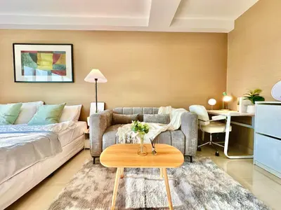 a living room with a couch and a table at Studio with view near Ekkamai in Bangkok