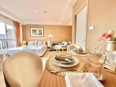a living room with a table and chairs and a bed at Studio with view near Ekkamai in Bangkok