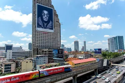 a city with a building with a large poster on it at The Studio at Sathorn Terrace in Bangkok