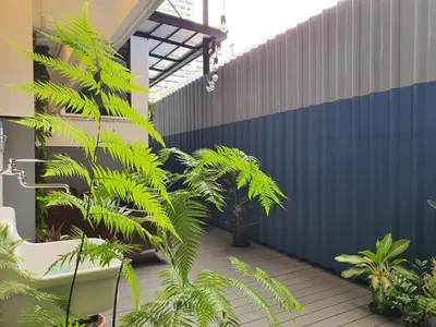 a courtyard with plants in front of a building at The Studio at Sathorn Terrace in Bangkok