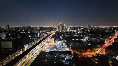 a view of a city at night with traffic at Lumpini park chatuchak in Bangkok