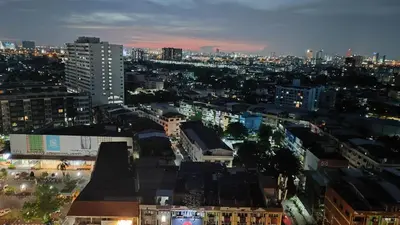 a view of a city at night at Lumpini park chatuchak in Bangkok