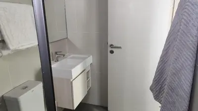 a white bathroom with a sink and a toilet at Lumpini park chatuchak in Bangkok