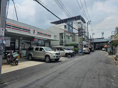 a street with cars parked on the side of the road at 95 Lodge in Bangkok