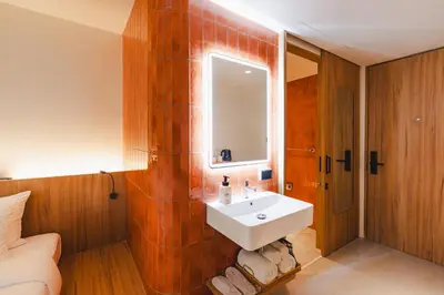 a bathroom with a sink and a mirror at VELA be Bangkok Siam in Bangkok