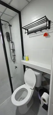 a bathroom with a white toilet and a shower at Homey Place easy access in Ban Song Hong