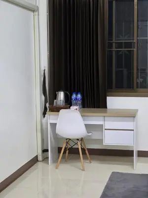 a white chair sitting in front of a desk at Homey Place easy access in Ban Song Hong