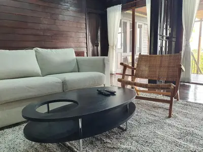 a living room with a couch and a coffee table at Baan Marrada Garden in Ban Pak Khlong Khwang