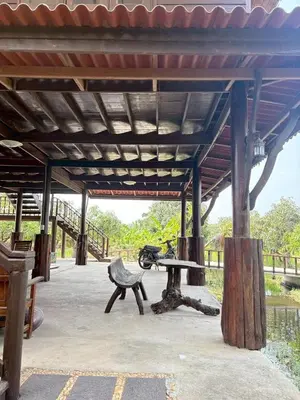 a pavilion with a picnic table and a bench at Baan Marrada Garden in Ban Pak Khlong Khwang