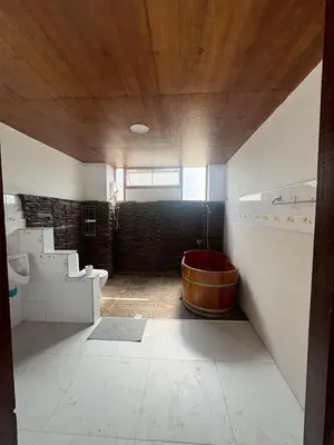 a bathroom with a tub in the middle of a room at Baan Marrada Garden in Ban Pak Khlong Khwang