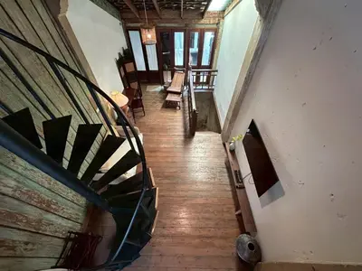 a hallway with a staircase in a building at Yellow House in Bangkok