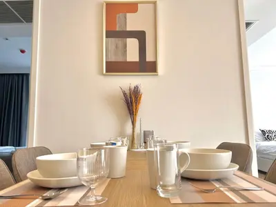 a dining room table with plates and glasses on it at Circle31 #2BR Bangkok in Bangkok