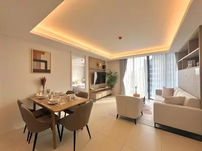 a dining room with a table and chairs and a couch at Circle31 #2BR Bangkok in Bangkok