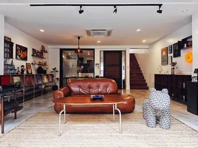 a living room with a leather couch and a coffee table at 4BR Modern Art Villa with Free Wi-Fi Netflix Vinyl in Bangkok