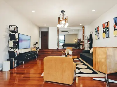 a living room with a couch and a tv at 4BR Modern Art Villa with Free Wi-Fi Netflix Vinyl in Bangkok