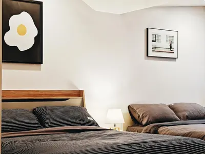 a bedroom with a bed and a picture of an egg on the wall at 4BR Modern Art Villa with Free Wi-Fi Netflix Vinyl in Bangkok