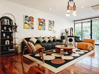 a living room with a couch and a table at 4BR Modern Art Villa with Free Wi-Fi Netflix Vinyl in Bangkok