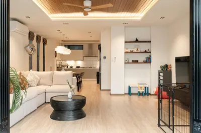 a living room with a white couch and a table at Asok house Sukhumvit27 Free BF in Bangkok