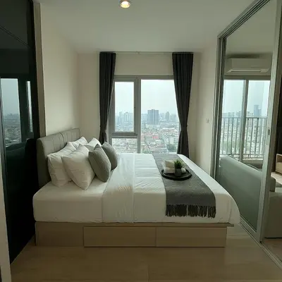 a bedroom with a large bed with a large window at High Floor Luxury Studio with Great Views in Bangkok