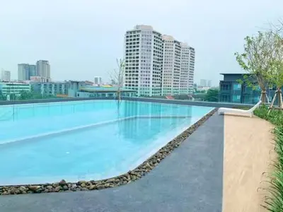a large swimming pool with blue water in a city at High Floor Luxury Studio with Great Views in Bangkok