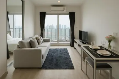 a white living room with a couch and a television at High Floor Luxury Studio with Great Views in Bangkok