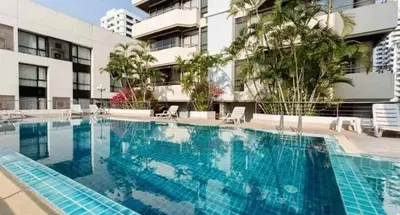 a large swimming pool in front of a building at Nana SkyView Retreat 2 Bedroom 2 Bath Nana BTS in Bangkok