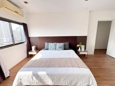 a bedroom with a large bed and two windows at Nana SkyView Retreat 2 Bedroom 2 Bath Nana BTS in Bangkok