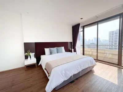 a bedroom with a large bed and a large window at Nana SkyView Retreat 2 Bedroom 2 Bath Nana BTS in Bangkok