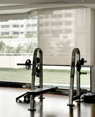 a gym with two treadmills in front of a window at Nana SkyView Retreat 2 Bedroom 2 Bath Nana BTS in Bangkok