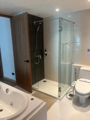a bathroom with a shower and a toilet at Stylish Apartment in Sukhumvit in Bangkok