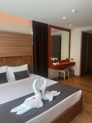 a bedroom with a bed with swans towels on it at Stylish Apartment in Sukhumvit in Bangkok
