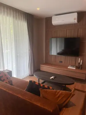 a living room with a couch and a table at Stylish Apartment in Sukhumvit in Bangkok