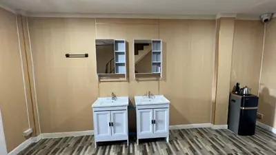 a bathroom with two white sinks and a mirror at Golden mango home Youth hostel \u91d1\u8292\u679c\u4e4b\u5bb6\u9752\u5e74\u65c5\u820d in Bangkok