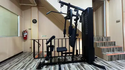 a room with a gym with a chair and stairs at Golden mango home Youth hostel \u91d1\u8292\u679c\u4e4b\u5bb6\u9752\u5e74\u65c5\u820d in Bangkok