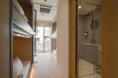 a room with a shower and a glass door at BEAT Warii Hostel at Chaophraya River in Bangkok