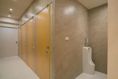 a bathroom with a shower and a urinal at BEAT Warii Hostel at Chaophraya River in Bangkok