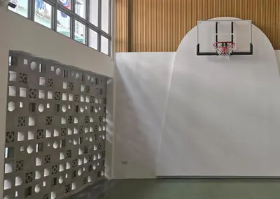 an empty gym with a basketball hoop on the wall at BEAT Warii Hostel at Chaophraya River in Bangkok