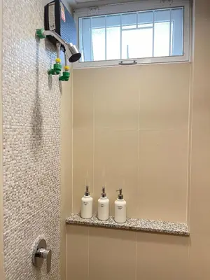 a bathroom with three rolls of toilet paper on a shelf at Nueng Rana 113 Unique House in Chinatown 3BR 2BA in Samphanthawong