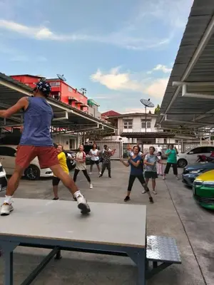 a group of people playing on a table in a parking lot at Sabai - Sabai in Bangkok