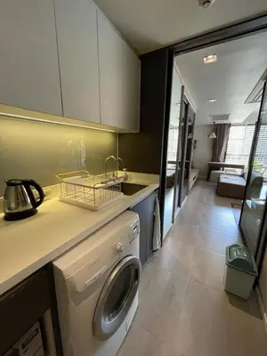 a kitchen with a washing machine in a room at 4Pax MRT BTS Asoke, Terminal21 in Bangkok