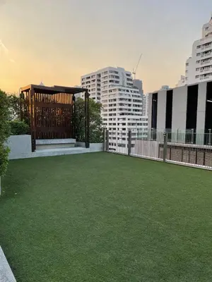 a large green yard with buildings in the background at 4Pax MRT BTS Asoke, Terminal21 in Bangkok