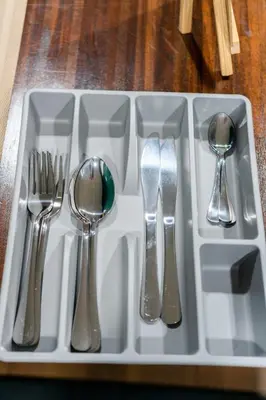 a tray with silver utensils on a table at The Sleepyard Sathorn 11 in Bangkok