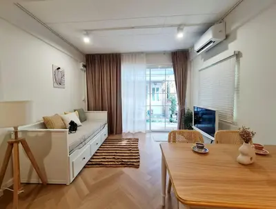 a living room with a couch and a table at Wanglang Home in Bangkok Noi