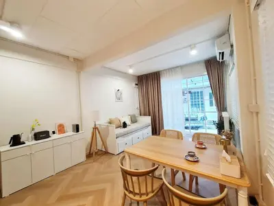 a kitchen and dining room with a wooden table and chairs at Wanglang Home in Bangkok Noi